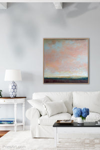 Large abstract coastal wall art "Retiring Sky," digital artwork by Victoria Primicias, decorates the living room.