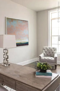 Large abstract landscape art "Retiring Sky," downloadable art by Victoria Primicias, decorates the office.