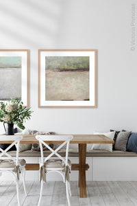 Neutral color landscape painting "Ruby Landing," digital print by Victoria Primicias, decorates the dining room.