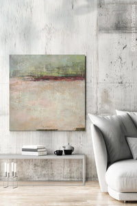 Neutral color abstract landscape painting "Ruby Landing," digital print by Victoria Primicias, decorates the living room.