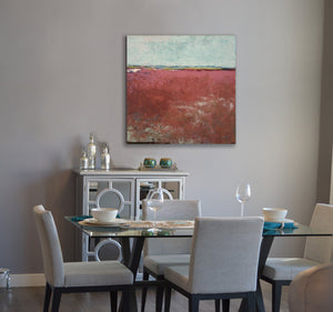 Red abstract ocean painting "Scarlet Sound," digital print by Victoria Primicias, decorates the dining room.