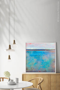 Contemporary blue abstract ocean wall art "Sea Mistress," printable wall art by Victoria Primicias, decorates the dining room.