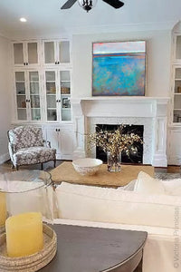 Turquoise abstract landscape painting "Sea Mistress," canvas print by Victoria Primicias, decorates the living room.