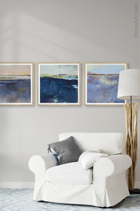 Indigo blue abstract landscape painting "Secret Waters," wall art print by Victoria Primicias, decorates the living room.