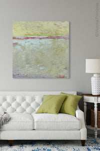 Muted beige abstract ocean painting "Sweet Compass," digital download by Victoria Primicias, decorates the living room.