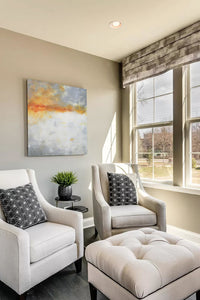 Contemporary abstract landscape art "Tawny Spirit," digital print by Victoria Primicias, decorates the living room.