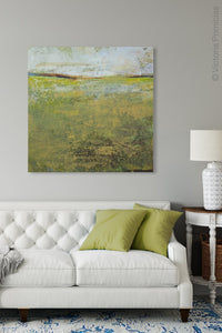 Yellow green abstract ocean wall art "Tender Reasons," digital print landscape by Victoria Primicias, decorates the living room.