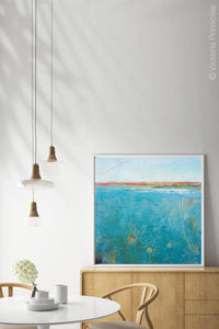 Teal abstract beach wall art "Tethered Basin," digital print by Victoria Primicias, decorates the dining room.
